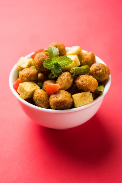 Soya chunks masala fry or meal maker fry using paneer or\
cottage cheese cubes and vegetables. popular healthy snack recipe\
from india. served in a bowl. selective focus