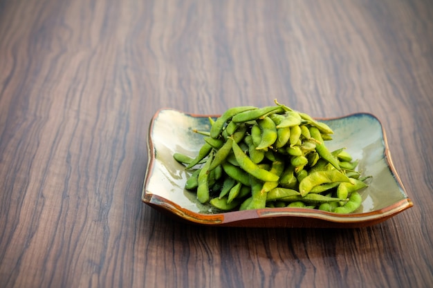 Soybean Japan put in a plate placed on a wooden table