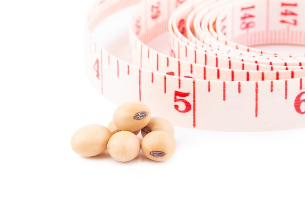 Soybean and white tape measuring isolated on white background. Healthy fruit concept