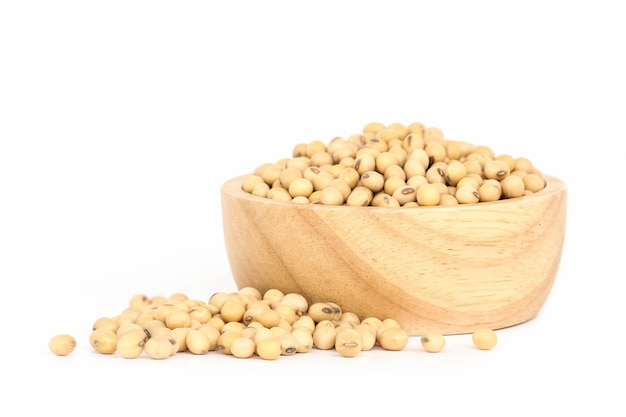 Soybean in wooden bowl isolated on white background.