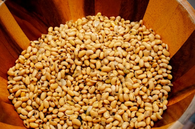 Soybeans closeup in wooden bowl ingredients Asian cooking to Salted Fermented Soy Bean Sauce as an ingredient in food flavoring that will provide nutritional value as a similar protein