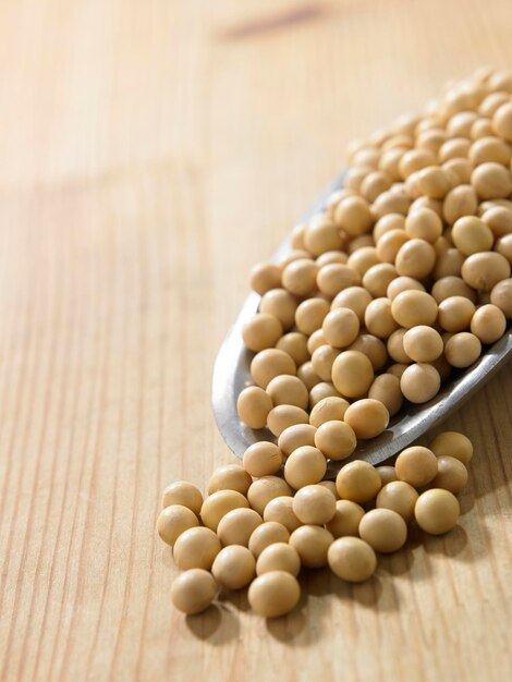 Soybeans in spoon on table