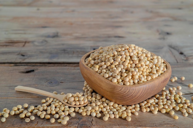 Soybeans in a wooden bowl and spoon background Soybeans are placed on the wooden table agricultural products