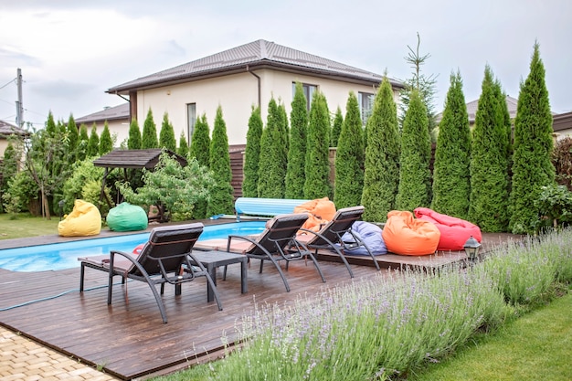 Spa area at backyard of home at summer swimming pool bright colorful soft chair happy vacation