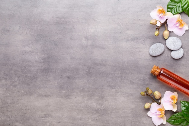 Spa aromatherapy background, flat lay of various beauty care products decorated with simple orchid flowers.