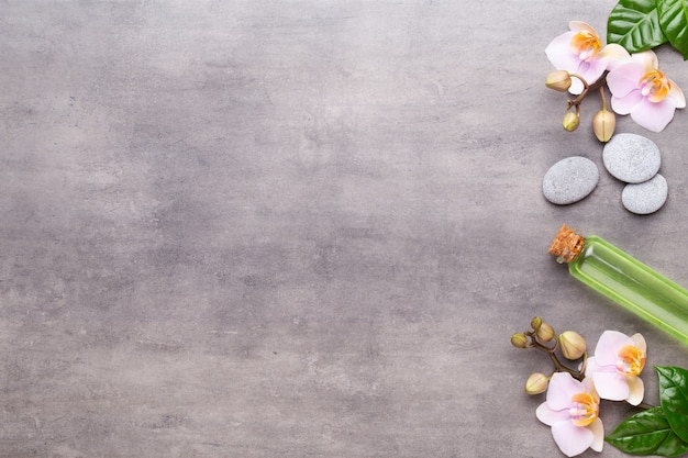 Spa aromatherapy background, flat lay of various beauty care products decorated with simple orchid flowers.