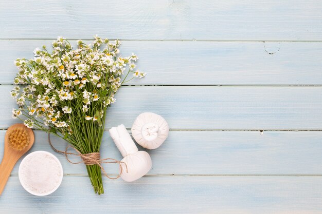 Spa aromatherapy beauty products decorated with simple chamomile flowers