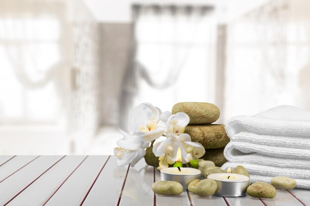 Spa aromatherapy concept with stack of clean towels on white table background, copy space.