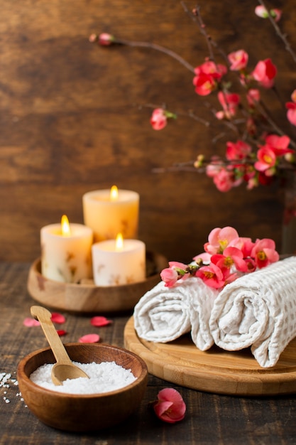 Spa arrangement with lit candles and towels