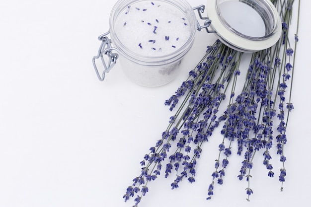 Spa background with dried lavender flowers and fragrant sea salt for bath and copy space. 