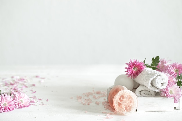 Spa background with products for personal hygiene and beauty with pink flowers. Hygiene and body care concept.