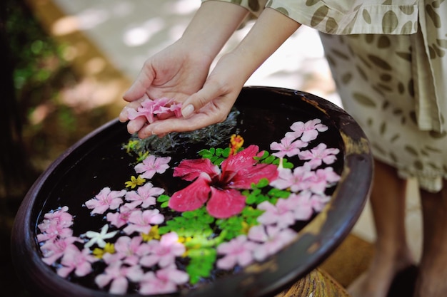 spa and beauty female hand and flower in water