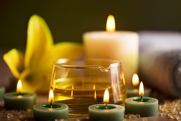 Spa center with herbal oil, candles and towel