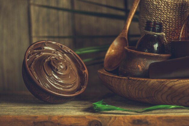 Spa chocolate mask Chocolate spa on wooden background Spa chocolate concept on a wooden background