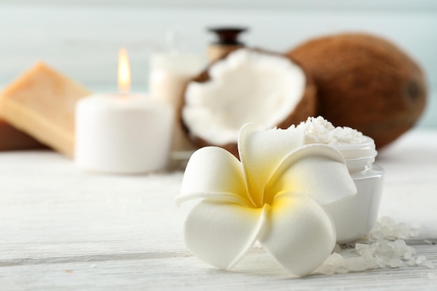 Spa coconut products on light wooden background