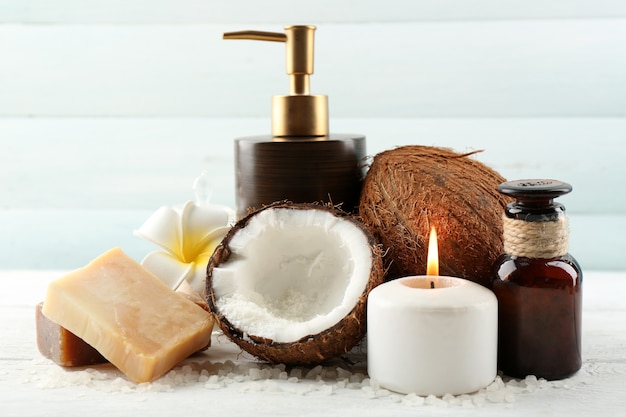 Spa coconut products on light wooden table