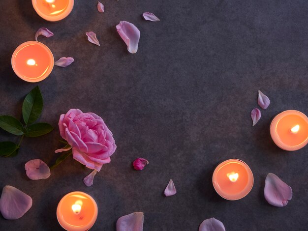 Spa composition of candles and rose.