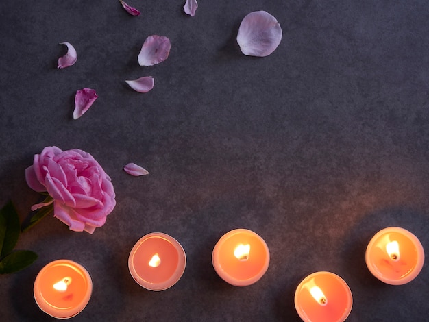 Spa composition of candles and rose.