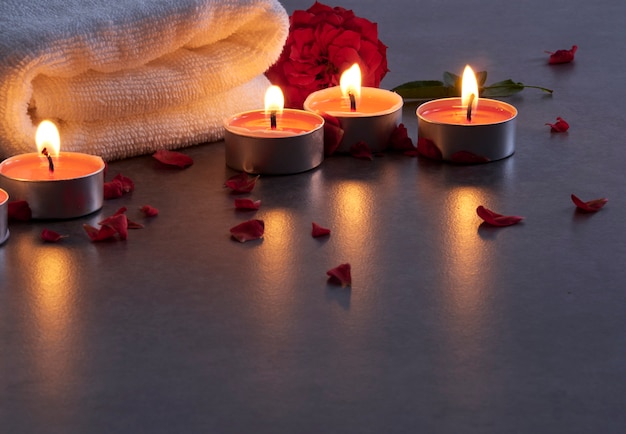 Spa composition of candles and rose.