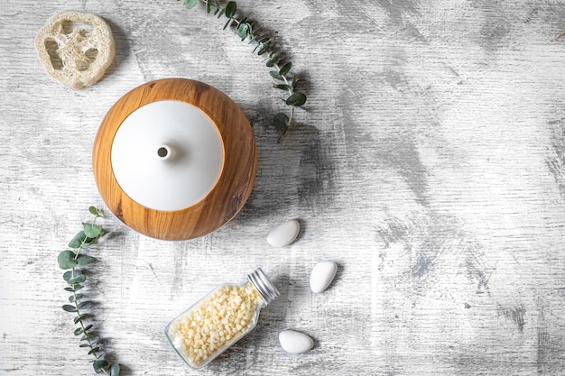 Spa composition with aroma diffuser on a textured background flat lay