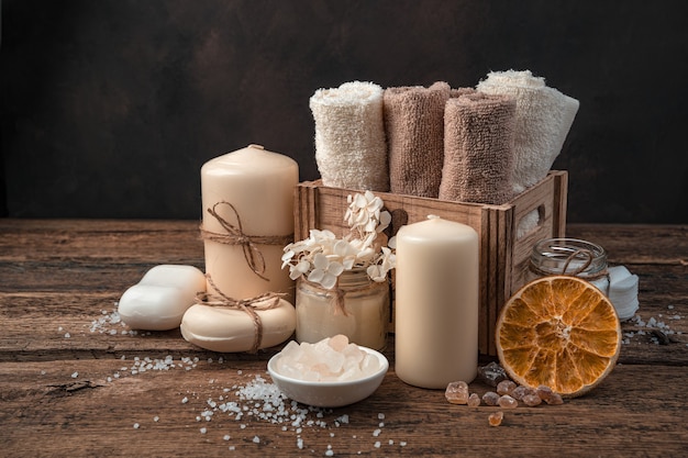Spa composition with body care items on a brown background.