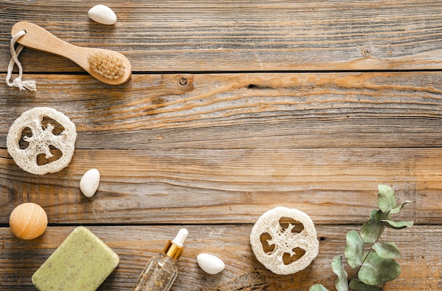 Spa composition with body care items on wooden background top view