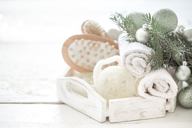 Spa composition with Christmas decoration on blurred background. Healthy lifestyle, body care, spa, and relaxation concept.