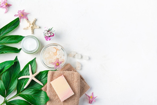 Spa composition with cream soap towel and salt on a white background