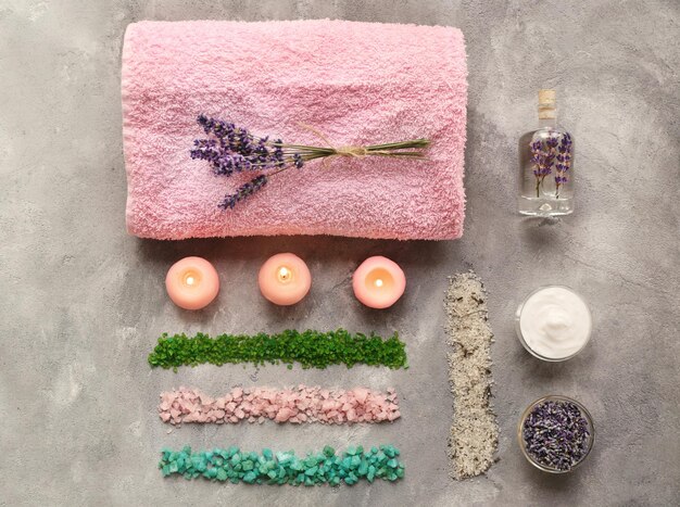 Spa composition with lavender towel and salt on gray background