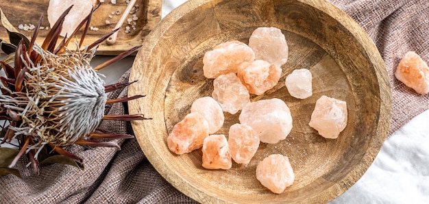 Spa composition with pieces of sea salt in a wooden plate