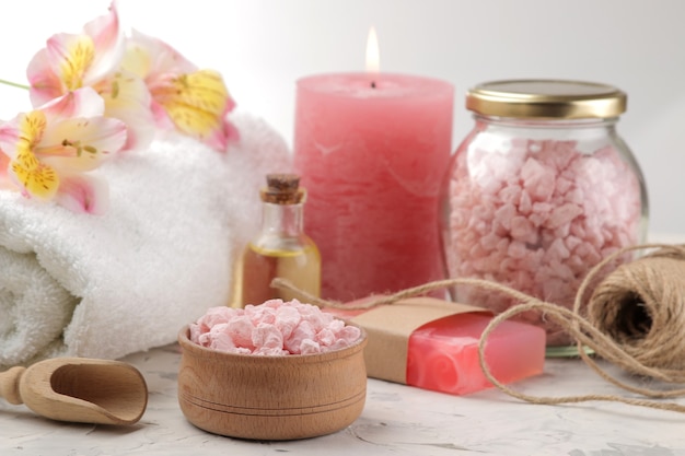 Spa composition with sea salt, aroma oils and handmade soap. spa concept. on a light background.