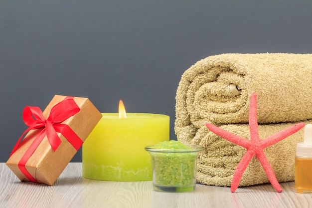 Spa composition with towel, gift box, sea salt and candle.