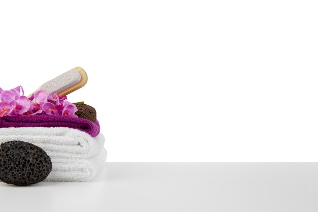 Spa composition with towels and flowers isolated on white