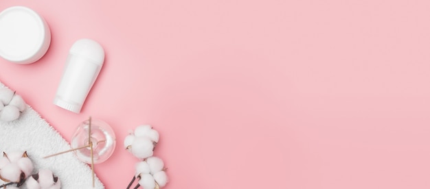 Spa concept, cotton white jars on a pink background, copy space, top view. High quality photo