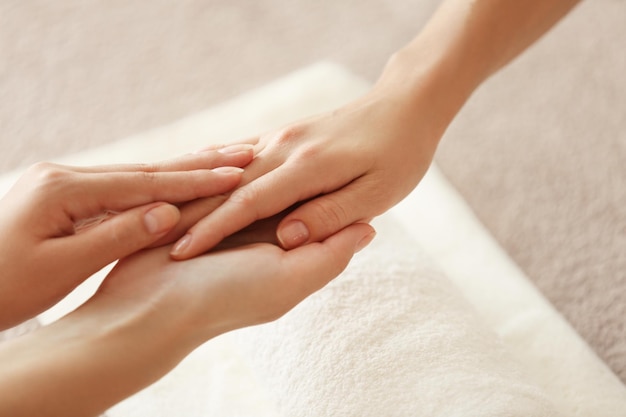 Spa concept Specialist massaging female hand