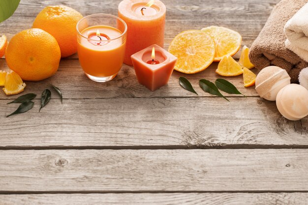 Spa concept with orange fruits on old wooden wall