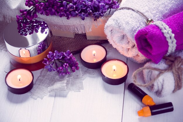 SPA consist from towels, lilac, candles, cream and oil 