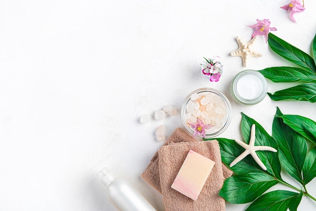 Spa elements towel soap salt cream and flowers on a white background