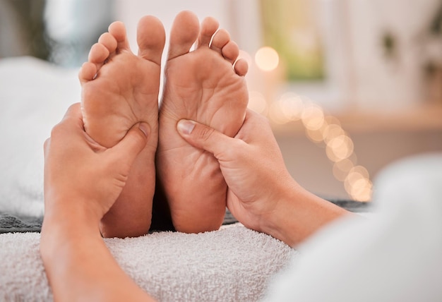 Spa feet and massage for relax wellness and health on bed with hands luxury and physical therapy Professional foot rub and service for healthcare foot massage and healthy body care treatment