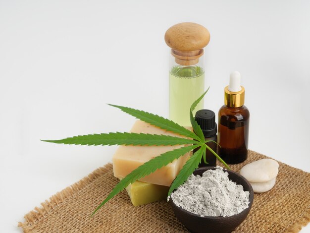 Spa hemp extract products with cannabis leaf soap bar cbd oil  lotion  and mud mask on burlap,sackcloth over white background