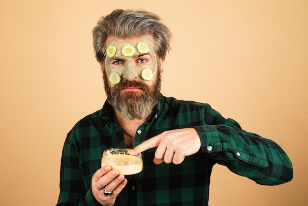 Premium Photo | Spa man applying facial clay mask funny man with facial ...