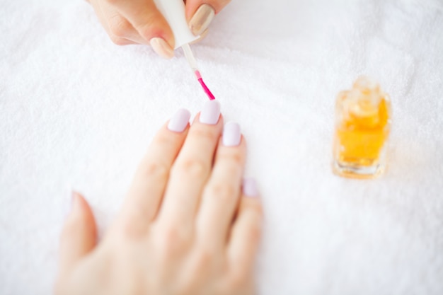 SPA manicure. French manicure at spa salon. Woman hands in a nail salon receiving a manicure procedure. Manicure procedure