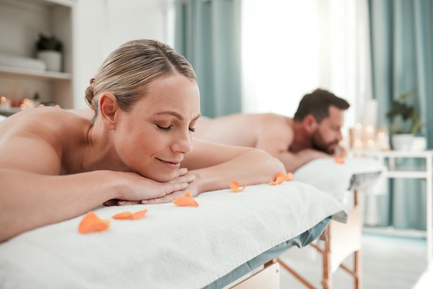 Spa massage and couple relax in luxury treatment for health wellness and therapy session at a resort Man and woman enjoying a calm day of zen care and relaxation lying on a table for vacation