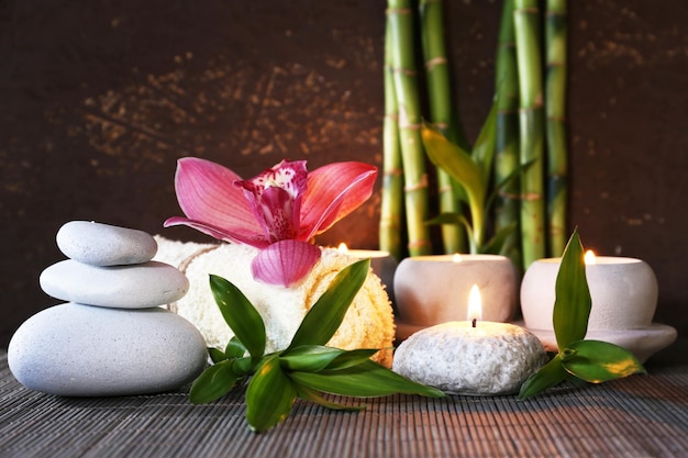 Spa set on bamboo mat on dark background