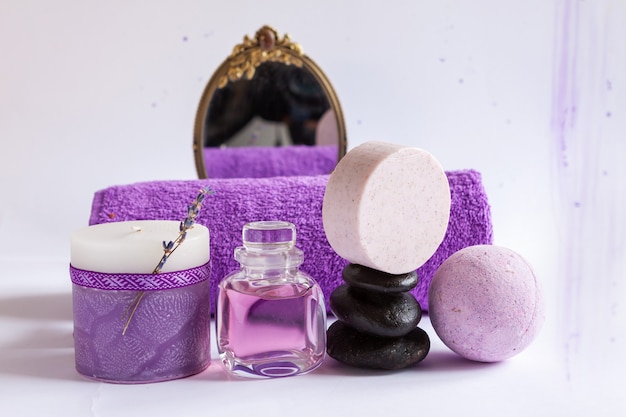 SPA set with natural lavender, candle, zen stones, mirror and towel. Concept for spa, beauty and health salon, cosmetics store. Close up on white background.