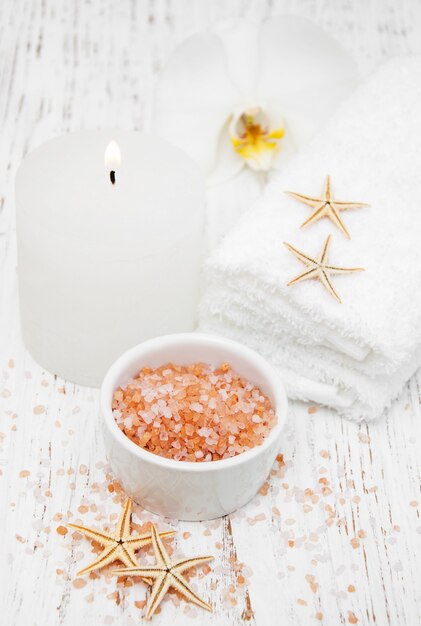 Spa setting with orchid, towels, candle and salt