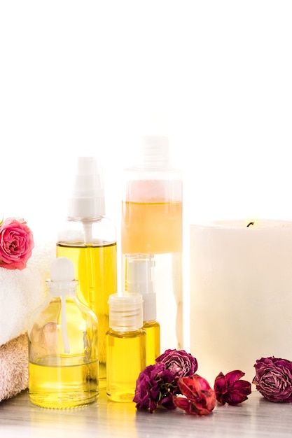 Spa setting with pink roses, sea salt and aroma oil, vintage style