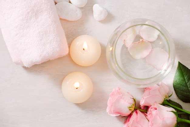 Spa settings with roses Spa theme with candles and flowers on table