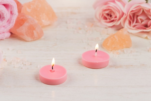 Spa settings with roses. Various items used in spa treatments on white wooden background.