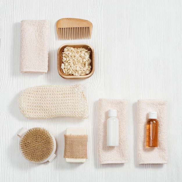 spa still life background set for body care on white wood bottles towels soap sea salt washcloth